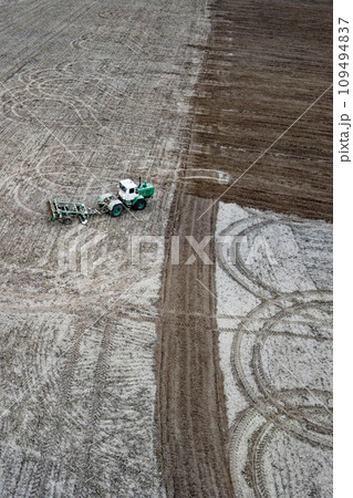 Tractor plows a field, aerial view. Agricultural landscape. 109494837