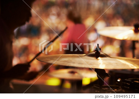 Drums, playing and closeup of hands, music festival and concert in outdoors, talent and audience. Band, performance and entertainment for crowd, instrument and rhythm for people, sound and rock Drums, playing and closeup of hands, music festival and concert in outdoors, talent and audience. Band, performance and entertainment for crowd, instrument and rhythm for people, sound and rock 109495171