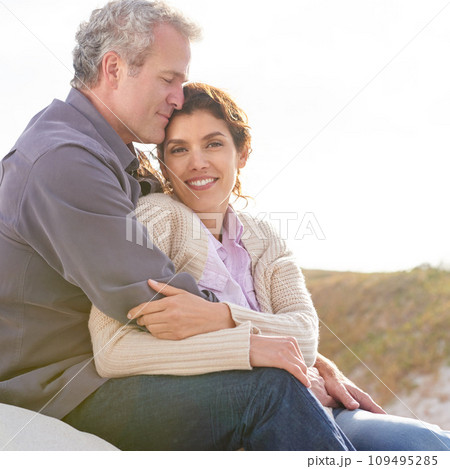 Couple, face and smile in nature with hug for romance, love and relationship outdoor with relaxing. Mature, man and woman or embrace with happy, peace and comfort for bonding, honeymoon and support 109495285