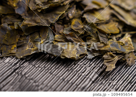 Dried kombu seaweed leaves. Traditional japanese dashi soup ingredient close up. Dry dehydrated algae.  109495654