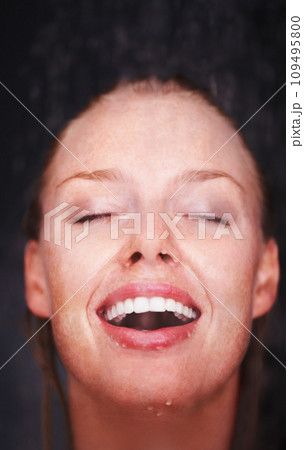 Shower, water splash and face of happy woman in a house for hygiene, fresh or stress relief closeup. Smile, bathroom and female person relax with cleaning, wellness or body care, skincare or routine 109495800