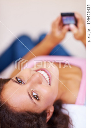 Portrait, smile and woman with phone on bed, social media and relax at home in the morning. Face, happy person on smartphone in bedroom and typing, scroll or communication on internet, mobile or app Portrait, smile and woman with phone on bed, social media and relax at home in the morning. Face, happy person on smartphone in bedroom and typing, scroll or communication on internet, mobile or app 109496436