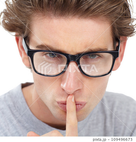 Secret, face and man in studio for sign of privacy, noise and confidential trust on white background. Portrait, guy with glasses and finger on lips for quiet, gossip news and mystery emoji to whisper Secret, face and man in studio for sign of privacy, noise and confidential trust on white background. Portrait, guy with glasses and finger on lips for quiet, gossip news and mystery emoji to whisper 109496673