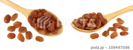 Brown raisins in wooden spoon isolated on white background . Top view. Flat lay 109497086