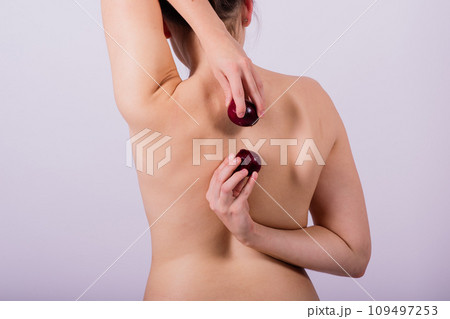 Cold, snot and flu protection, woman with onion, white background. Female person topless Cold, snot and flu protection, woman with onion, white background. Female person topless 109497253