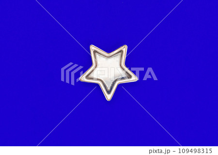 Christmas five pointed golden star on blue background. Christmas decoration. Christmas five pointed golden star on blue background. Christmas decoration. 109498315