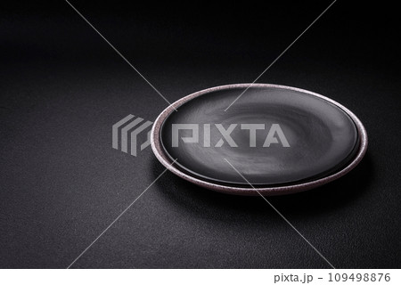 Empty round ceramic plate as an item of kitchen utensils Empty round ceramic plate as an item of kitchen utensils 109498876