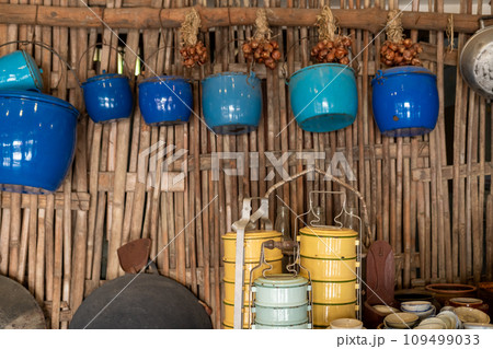 Food containers and pots in the walls of a traditional Asian kitchen. 109499033