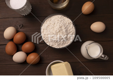 Top View Of Ingredients Wheat Flour, Eggs, Milk, Butter, Sugar, Cognac On Wooden Table For Sakotis Or Raguolis, Traditional Christmas Spit Cake. 109500005