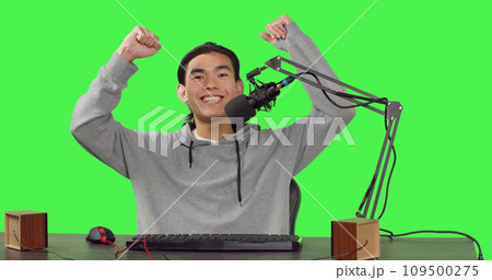 POV of content creator on live stream recording gameplay of new action video game launched, greenscreen backdrop. Asian streamer broadcasting multiplayer competition, streaming with microphone. POV of content creator on live stream recording gameplay of new action video game launched, greenscreen backdrop. Asian streamer broadcasting multiplayer competition, streaming with microphone. 109500275