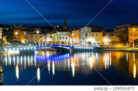 View of evening embankment with illuminations of city of Martigues. France 109503473
