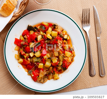 Plate of stewed vegetables on table. Vegetarian dish Plate of stewed vegetables on table. Vegetarian dish 109503827