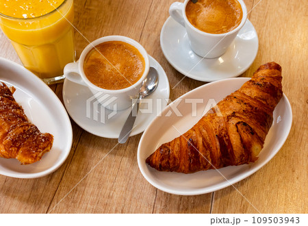 Fresh crisp delicious French croissant with cup of fragrant coffee 109503943
