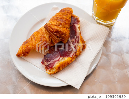 Croissant with ham served on platter Croissant with ham served on platter 109503989