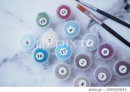 Paints and paint brushes in an artists studio. Paints and paint brushes in an artists studio. 109504645