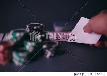 Dealer or croupier shuffles poker cards in a casino on the background of a table, chips. Concept of poker game, game business. Playing for money, a big win, a jackpot, gambling, a desire to get rich. Dealer or croupier shuffles poker cards in a casino on the background of a table, chips. Concept of poker game, game business. Playing for money, a big win, a jackpot, gambling, a desire to get rich. 109505580