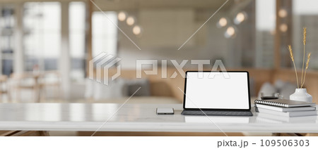 A white-screen digital tablet mockup on a white tabletop in a modern beautiful coffee shop. 109506303