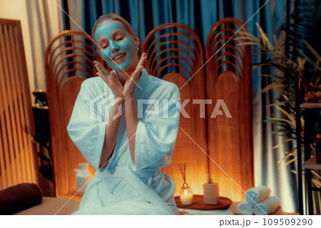 Woman indulges in rejuvenating with luxurious face cream spa massage. Quiescent 109509290