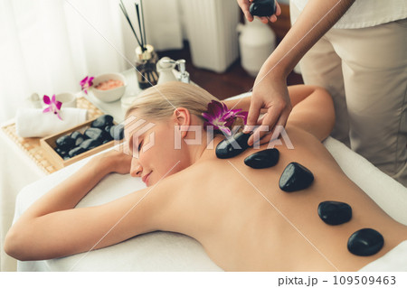 Hot stone massage at spa salon in luxury resort. Quiescent 109509463