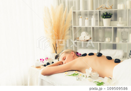 Hot stone massage at spa salon in luxury resort. Quiescent 109509586