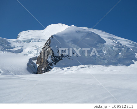 Saas-Fee, Switzerland - June 16th 2023: View back to Strahlhorn peak over wide glacier landscapes. Saas-Fee, Switzerland - June 16th 2023: View back to Strahlhorn peak over wide glacier landscapes. 109512213