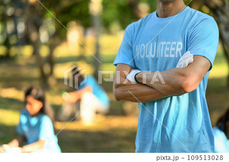 Man in volunteer uniform standing with arms crossed while standing outdoor. Charity and community service concept 109513028