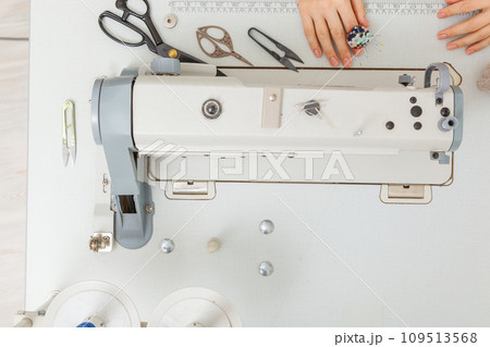 Top view sewing machine with sewing tools, scissors, thread Top view sewing machine with sewing tools, scissors, thread 109513568