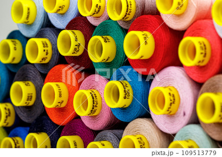 set of multi-colored spools of thread for sewing 109513779