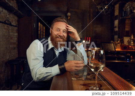 Happy smiling drunk man with glass in the bar 109514439