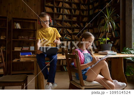 Brother and sister schoolchildren studying at home together Brother and sister schoolchildren studying at home together 109514524