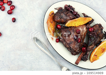 Baked chicken legs with orange and berries. Baked chicken legs with orange and berries. 109514909