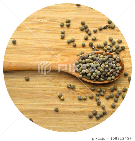 Dried okra seeds in wooden spoon, on bamboo cutting board Dried okra seeds in wooden spoon, on bamboo cutting board 109518457