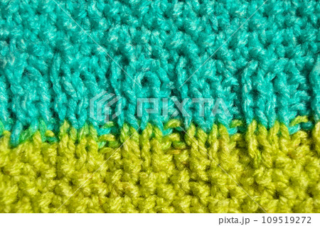 Handmade knitted fabric blue and green yellow wool background texture Handmade knitted fabric blue and green yellow wool background texture 109519272