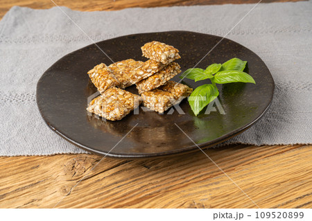 Sunflower Seeds Bar on Black Plate, Energy Snack with Honey, Sun Flower Seed Muesli Dessert Sunflower Seeds Bar on Black Plate, Energy Snack with Honey, Sun Flower Seed Muesli Dessert 109520899