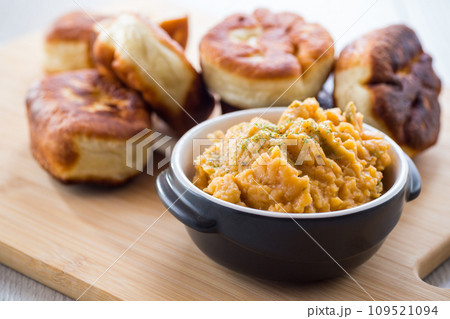 Fried Lenten pies filled with cooked peas inside, on a wooden table. 109521094