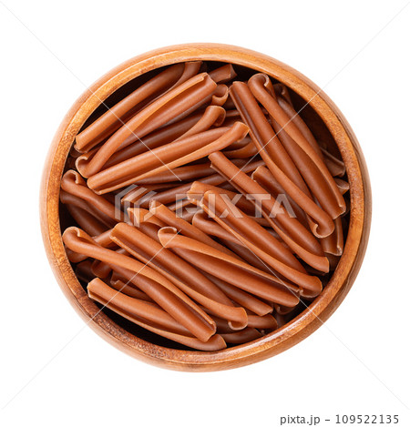 Casarecce pasta in a wooden bowl. Gluten free pasta, made with the flour of red lentils,  chickpeas and rice. Short twists of pasta originating from Sicily which appear rolled up on themselves. Photo. 109522135