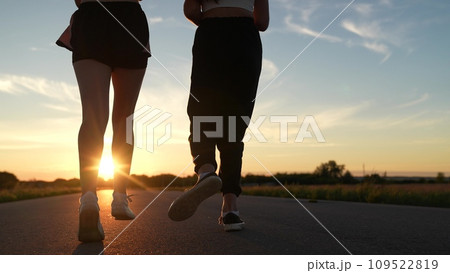 two friends running sunset, team group girls running sunset, silhouette athletic girls, teamwork running training sunset. runner silhouette, mixed race, treadmill sunset, athletic body, club like 109522819