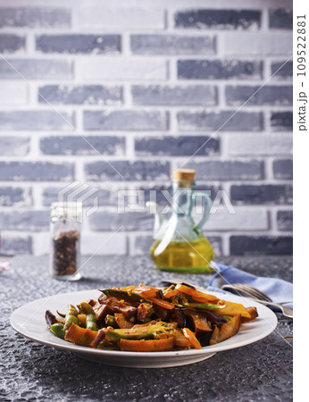 Chopped cooked vegetables on dark background, Traditional ratatouille with zucchini, bell pepper and eggplant 109522881