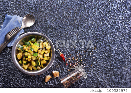 Sliced spiced zucchini with oil, salt and garlic Sliced spiced zucchini with oil, salt and garlic 109522973
