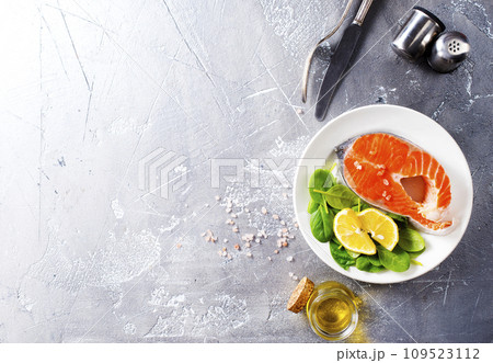 raw salmon steaks and different spices, diet food raw salmon steaks and different spices, diet food 109523112