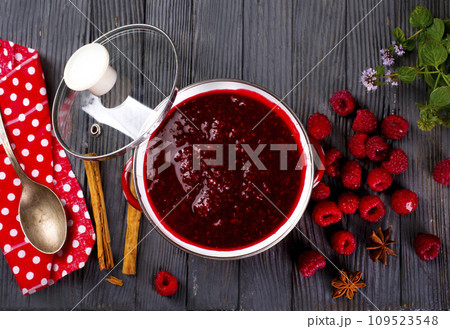 Raspberry jam with berry on dark background. 109523548
