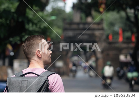 Traveler walking on busy street in Hanoi. 109523834