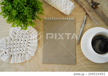Tools and materials for macrame. Cotton ropes, sticks from the river, grinded by water. Notepad with an empty space for writing. Concept diy. Tools and materials for macrame. Cotton ropes, sticks from the river, grinded by water. Notepad with an empty space for writing. Concept diy. 109524491