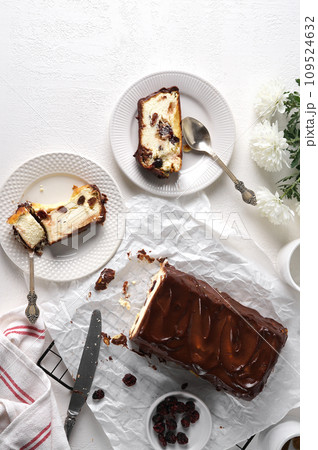 Lviv cheesecake, a traditional Ukrainian dessert with raisins, coated with chocolate icing Lviv cheesecake, a traditional Ukrainian dessert with raisins, coated with chocolate icing 109524632
