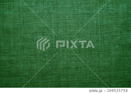 Fabric texture background. Green fabric with weave. Natural slightly wrinkled look of the material. Uniform copy space background. Cotton, canvas or woolen thin fabric laid evenly on the surface 109525758