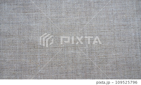 Fabric texture background. Gray fabric with weave. Natural slightly wrinkled look of the material. Uniform copy space background. Cotton, canvas or woolen thin fabric laid evenly on the surface 109525796