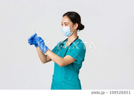 Covid-19, coronavirus disease, healthcare workers concept. Profile of asian female doctor, nurse in medical mask and globes, fill syringe with vaccine, doing vaccination shots, white background Covid-19, coronavirus disease, healthcare workers concept. Profile of asian female doctor, nurse in medical mask and globes, fill syringe with vaccine, doing vaccination shots, white background 109526851