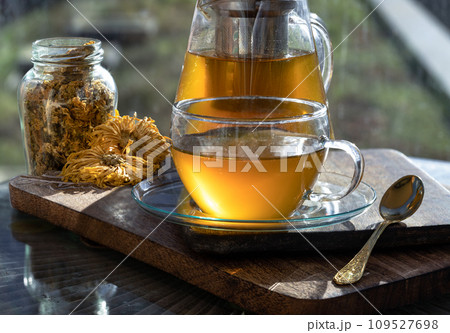 Chinese chrysanthemum flower tea and Dried chrysanthemum flower on wooden cutting board. Chinese chrysanthemum flower tea and Dried chrysanthemum flower on wooden cutting board. 109527698