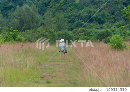 An asian adult traveler in savannah field at Phangnga province 109534550