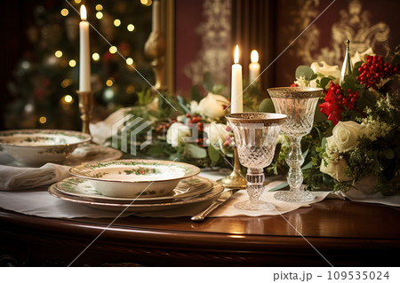 Holiday dining table set with vintage china, antique silverware, and classic Christmas centerpieces 109535024